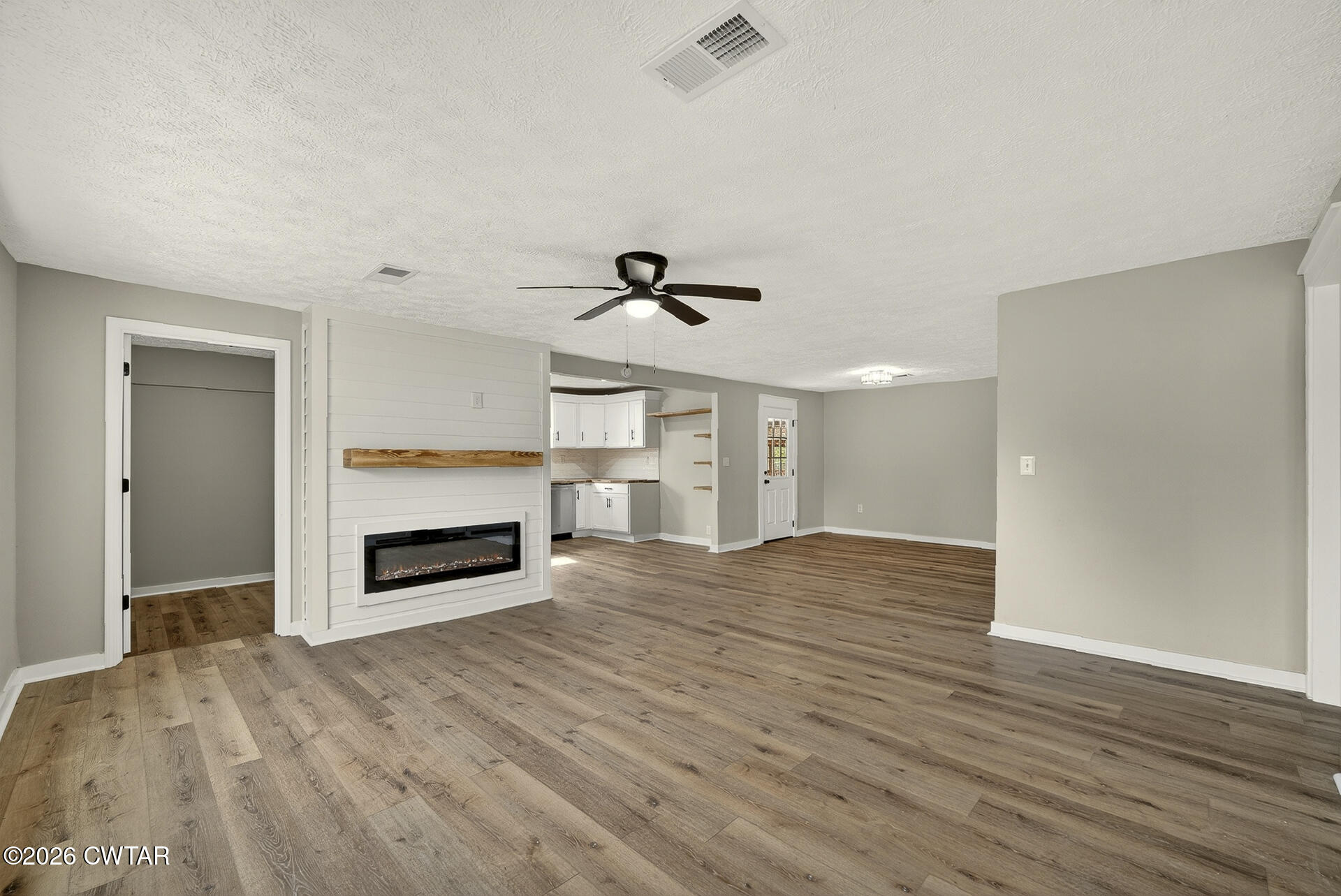 402 Harts Bridge Road Jackson, TN 38301 - Photo 3 of 38 a view of empty room with wooden floor fireplace and windows