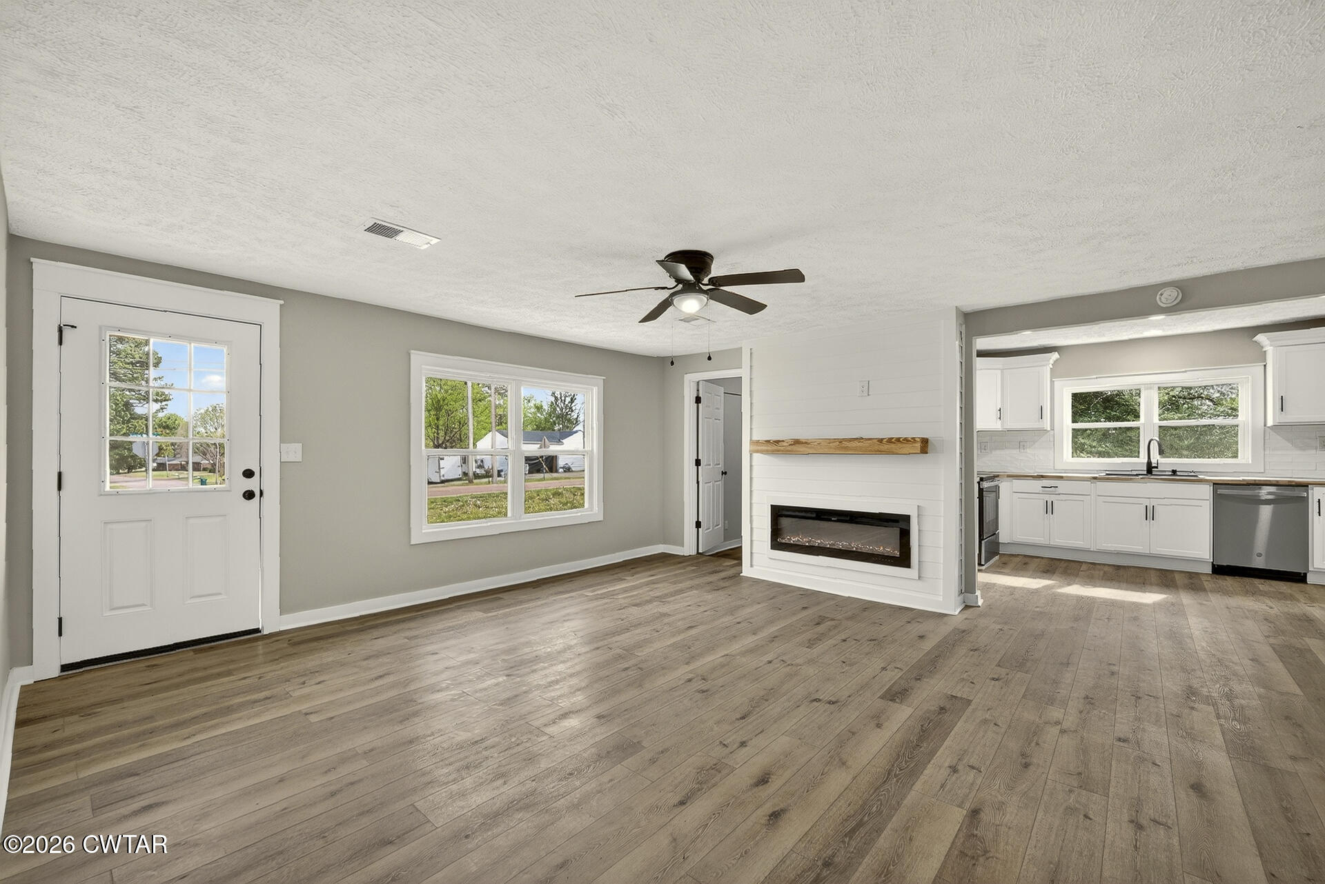 402 Harts Bridge Road Jackson, TN 38301 - Photo 4 of 38 an empty room with windows and fireplace