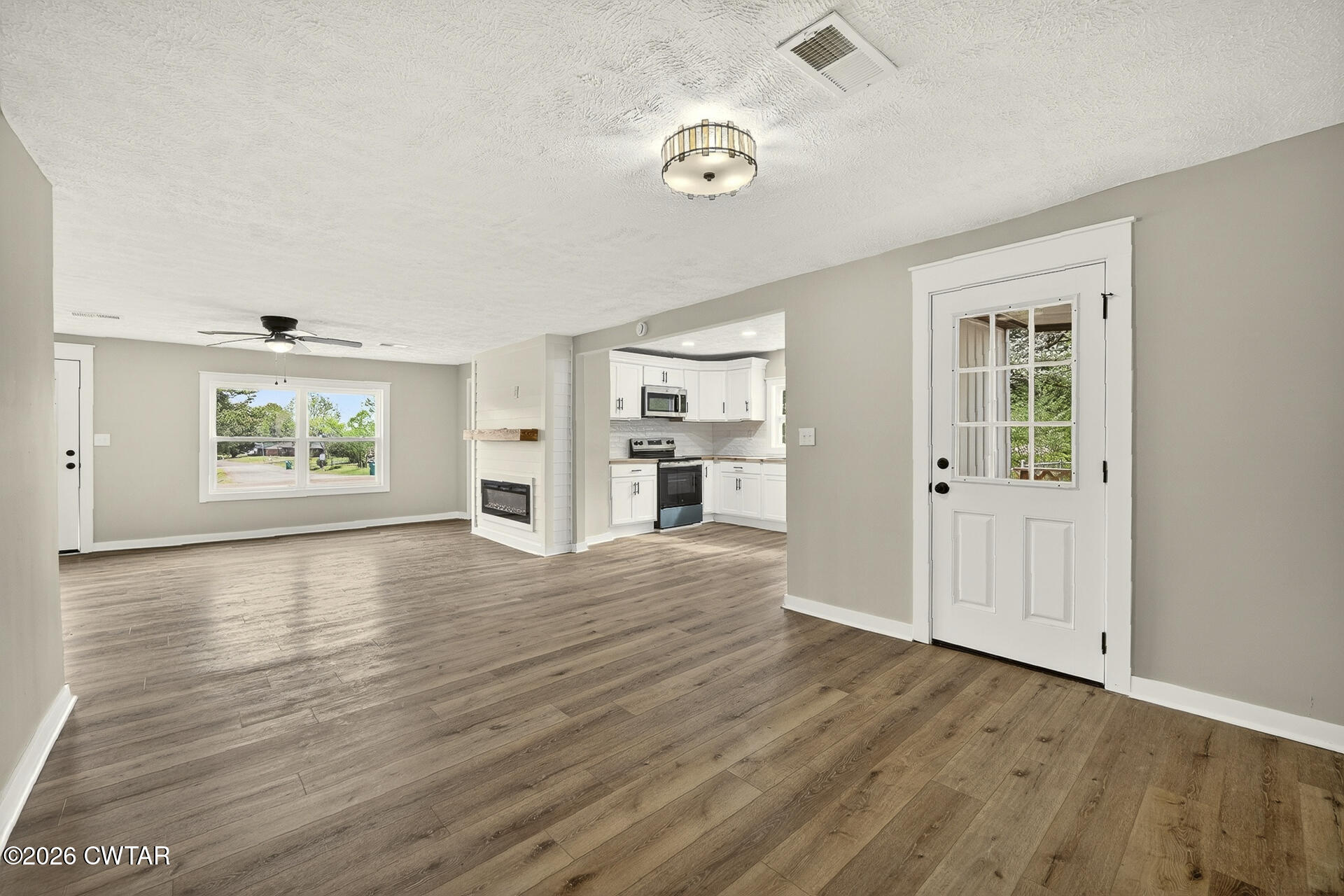 402 Harts Bridge Road Jackson, TN 38301 - Photo 10 of 38 an empty room with wooden floor and windows