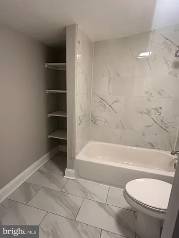 a bathroom with a toilet a sink and bathtub