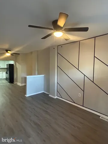 a view of a kitchen with a sink and a refrigerator