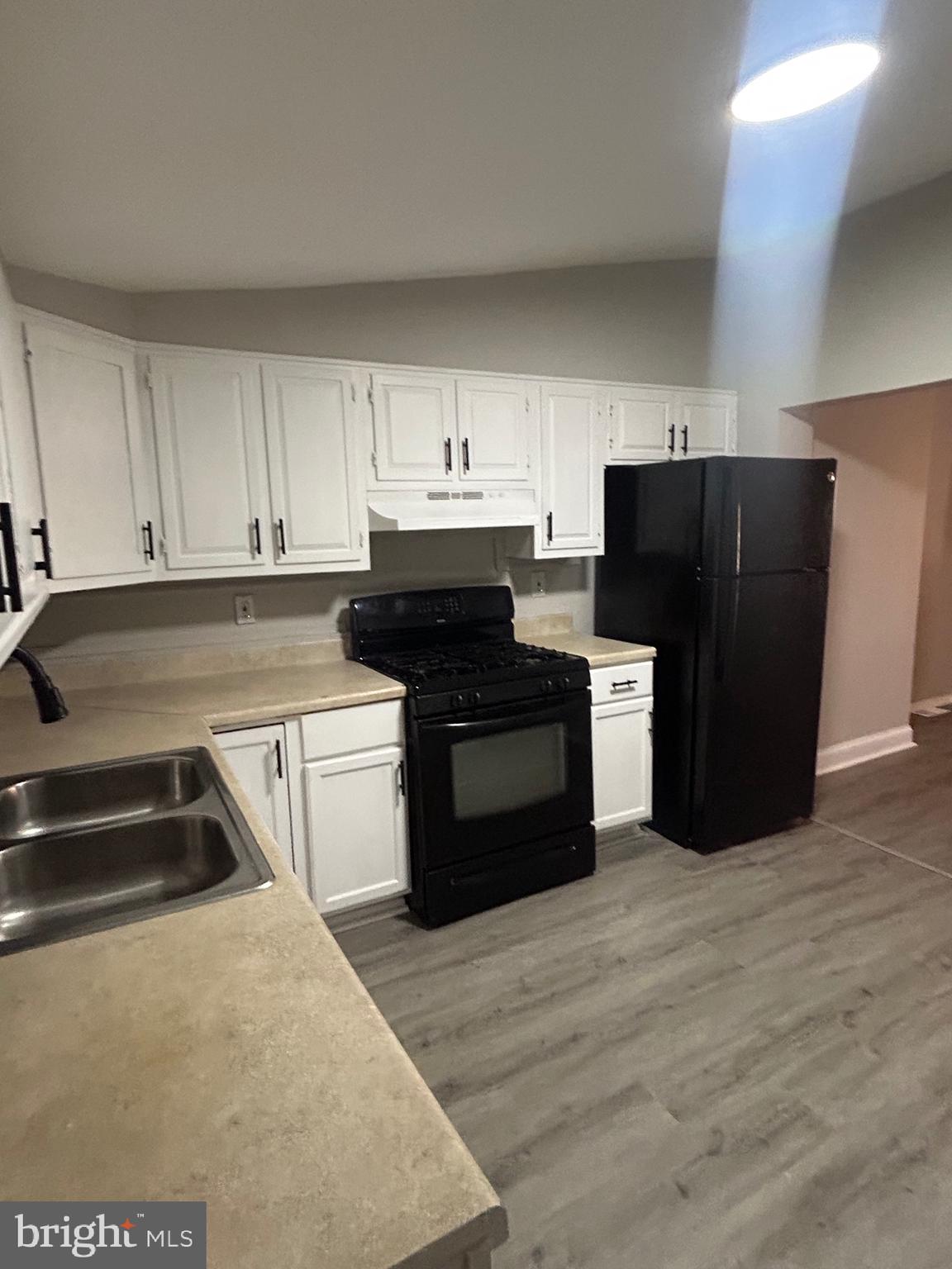 1807 Ramsay Street Baltimore, MD 21223 - Photo 5 of 13 a kitchen with a sink a stove and refrigerator