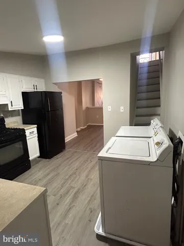 a kitchen with granite countertop a sink cabinets and stainless steel appliances