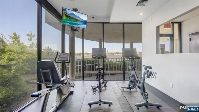 a room with gym equipment and a floor to ceiling window