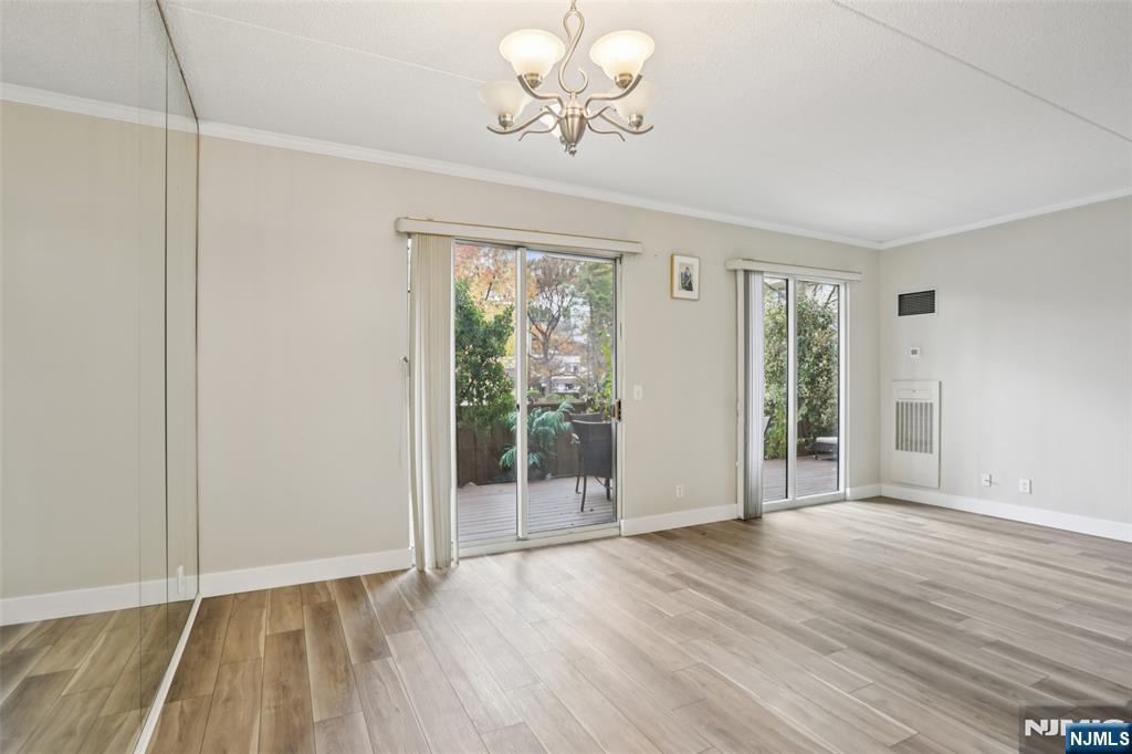1077 River Road, Unit TH5 Edgewater, NJ 07020 - Photo 5 of 21 a view of an empty room with wooden floor and a window