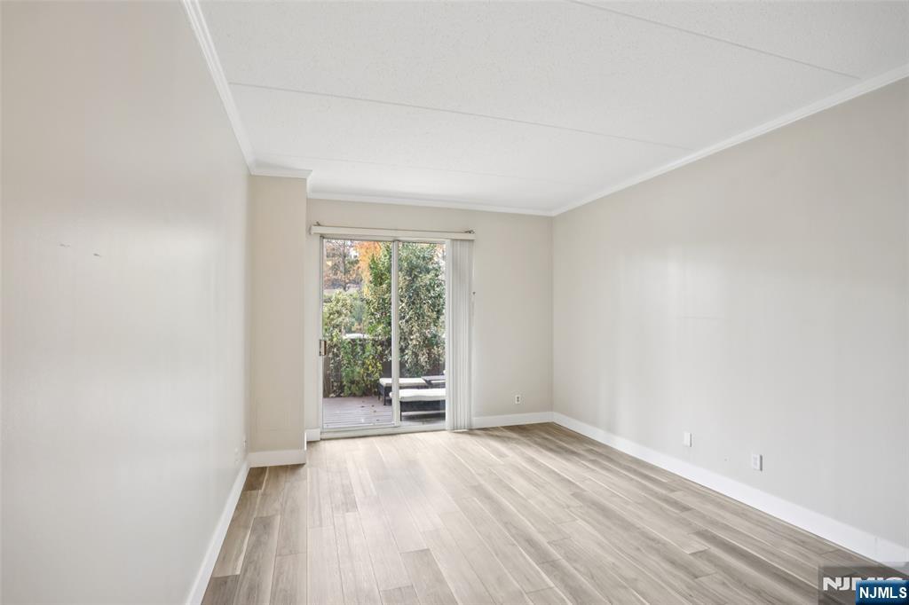 1077 River Road, Unit TH5 Edgewater, NJ 07020 - Photo 7 of 21 an empty room with wooden floor and windows
