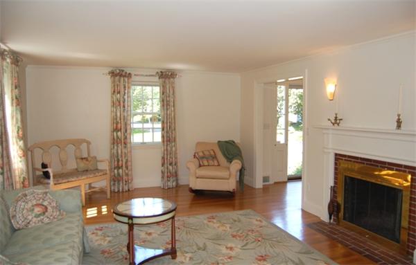 32 Sherburne Road Lexington, MA 02421 - Photo 3 of 24 a living room with furniture a fireplace and a table
