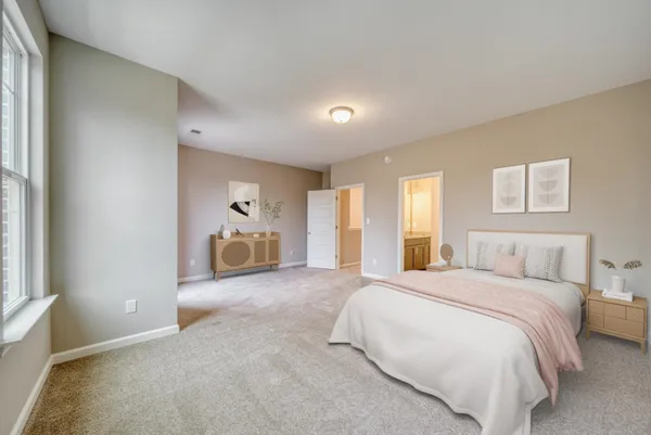 a spacious bedroom with a bed and window