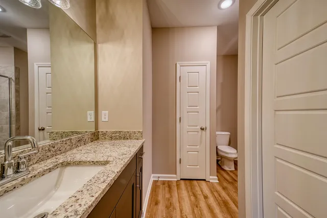 a bathroom with a granite countertop sink and a mirror