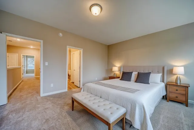 a bedroom with a bed and a lamp