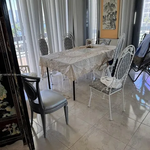 a view of a dining room with furniture and a window