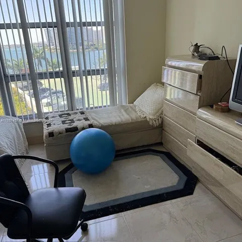 a living room with furniture and a floor to ceiling window