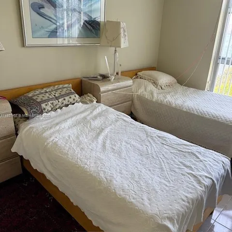 a bedroom with bed and painting on the wall