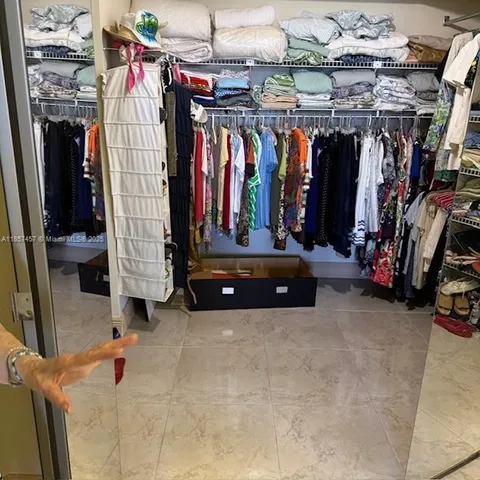 a view of walk in closet with clothes
