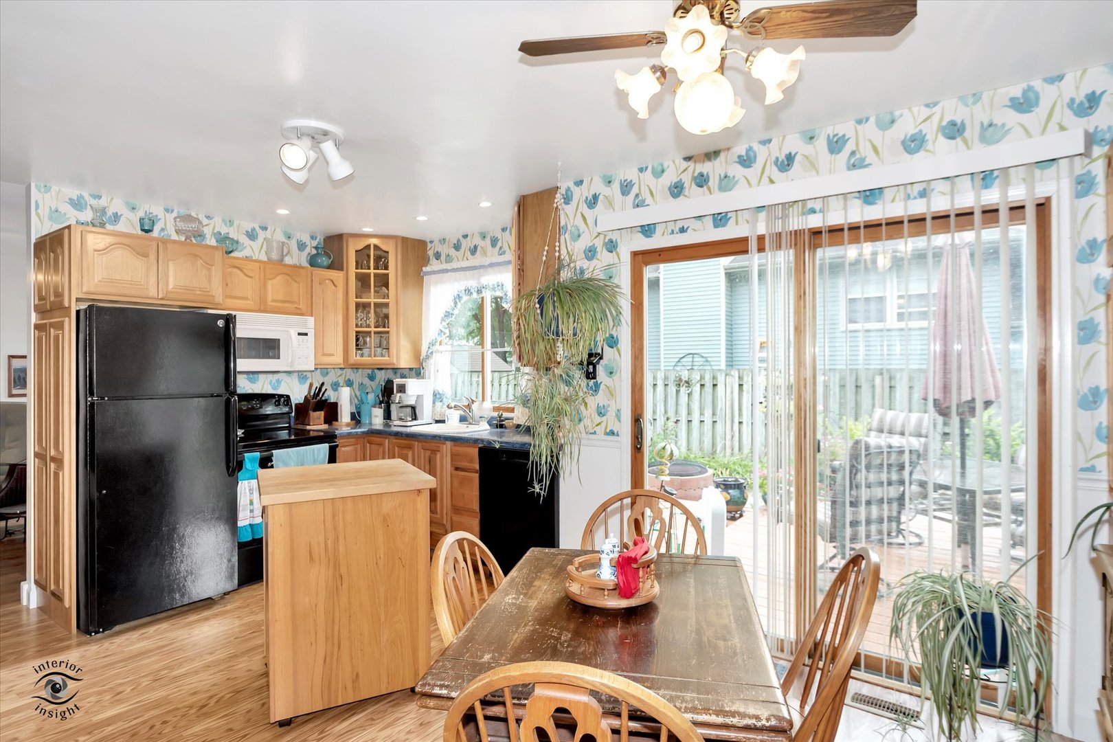 605 Ridge Street Wilmington, IL 60481 - Photo 14 of 26 a kitchen with stainless steel appliances granite countertop a refrigerator a oven a stove and a dining table with wooden floor