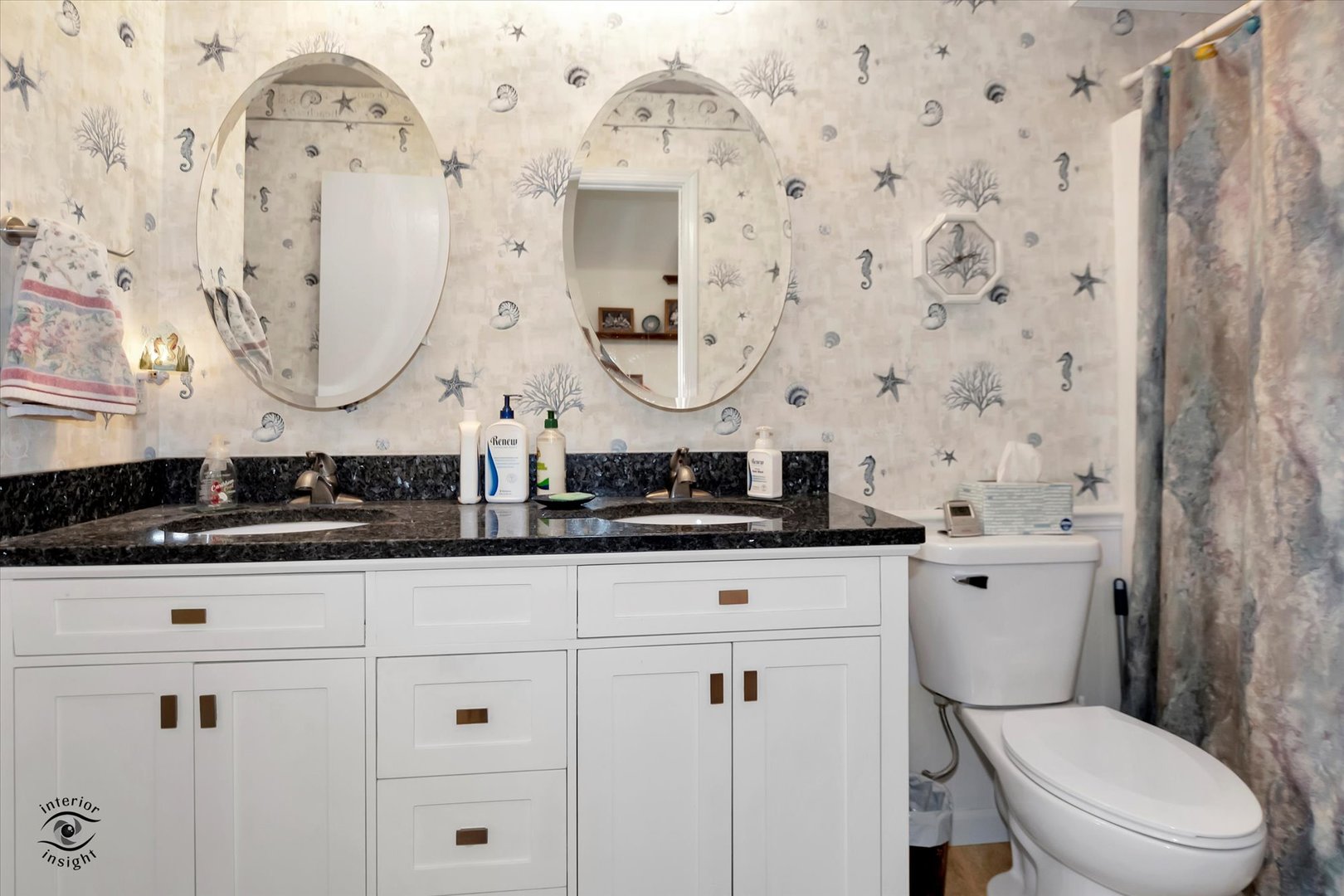 605 Ridge Street Wilmington, IL 60481 - Photo 22 of 26 a bathroom with a granite countertop toilet sink and mirror