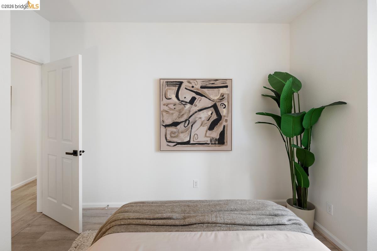 2029 Channing Way, Unit 3D Berkeley, CA 94704 - Photo 44 of 54 Bedroom featuring light-colored walls and wood-finish flooring
