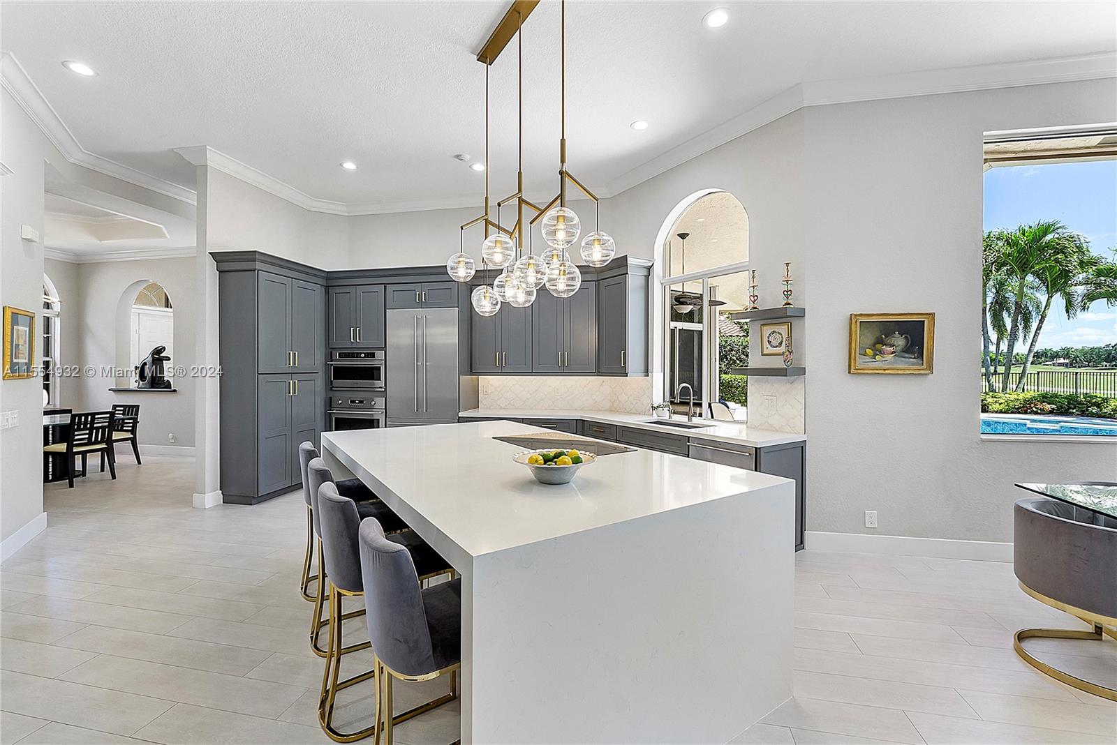 2539 Eagle Run Drive Weston, FL 33327 - Photo 17 of 64 a kitchen with a refrigerator a sink dishwasher a dining table and chairs with wooden floor