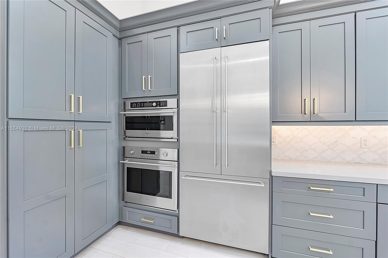 2539 Eagle Run Drive Weston, FL 33327 - Photo 19 of 64 a white refrigerator freezer and cabinets in a kitchen