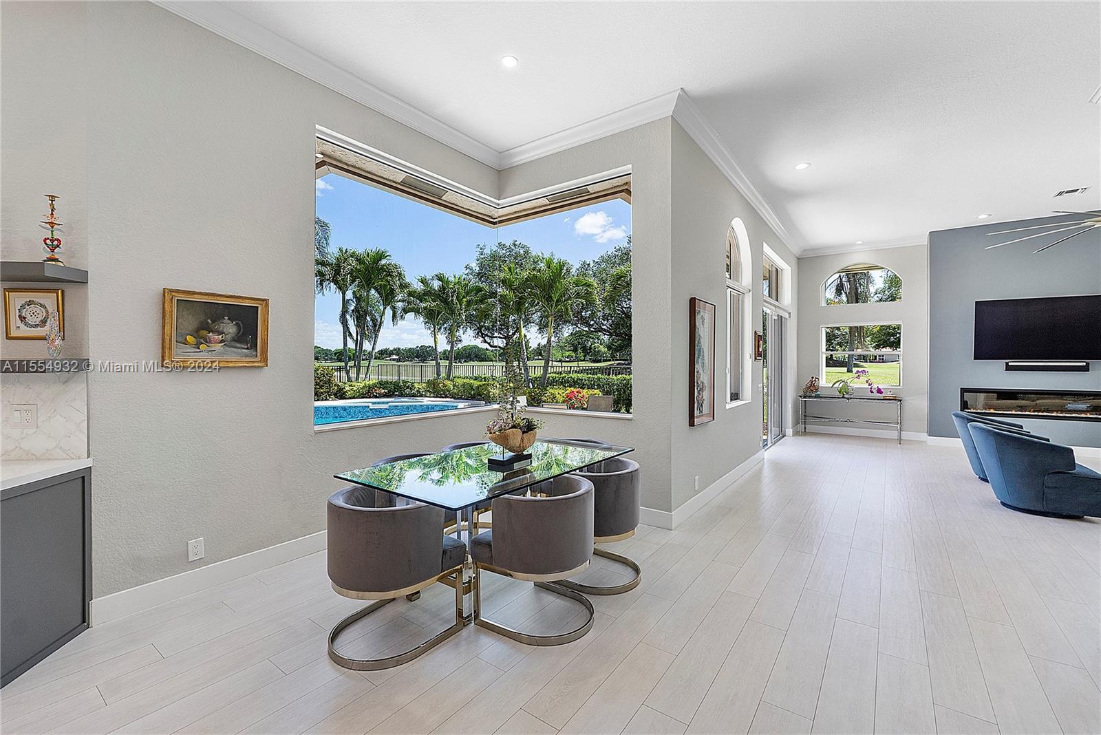 2539 Eagle Run Drive Weston, FL 33327 - Photo 21 of 64 a living room with furniture a flat screen tv and floor to ceiling window