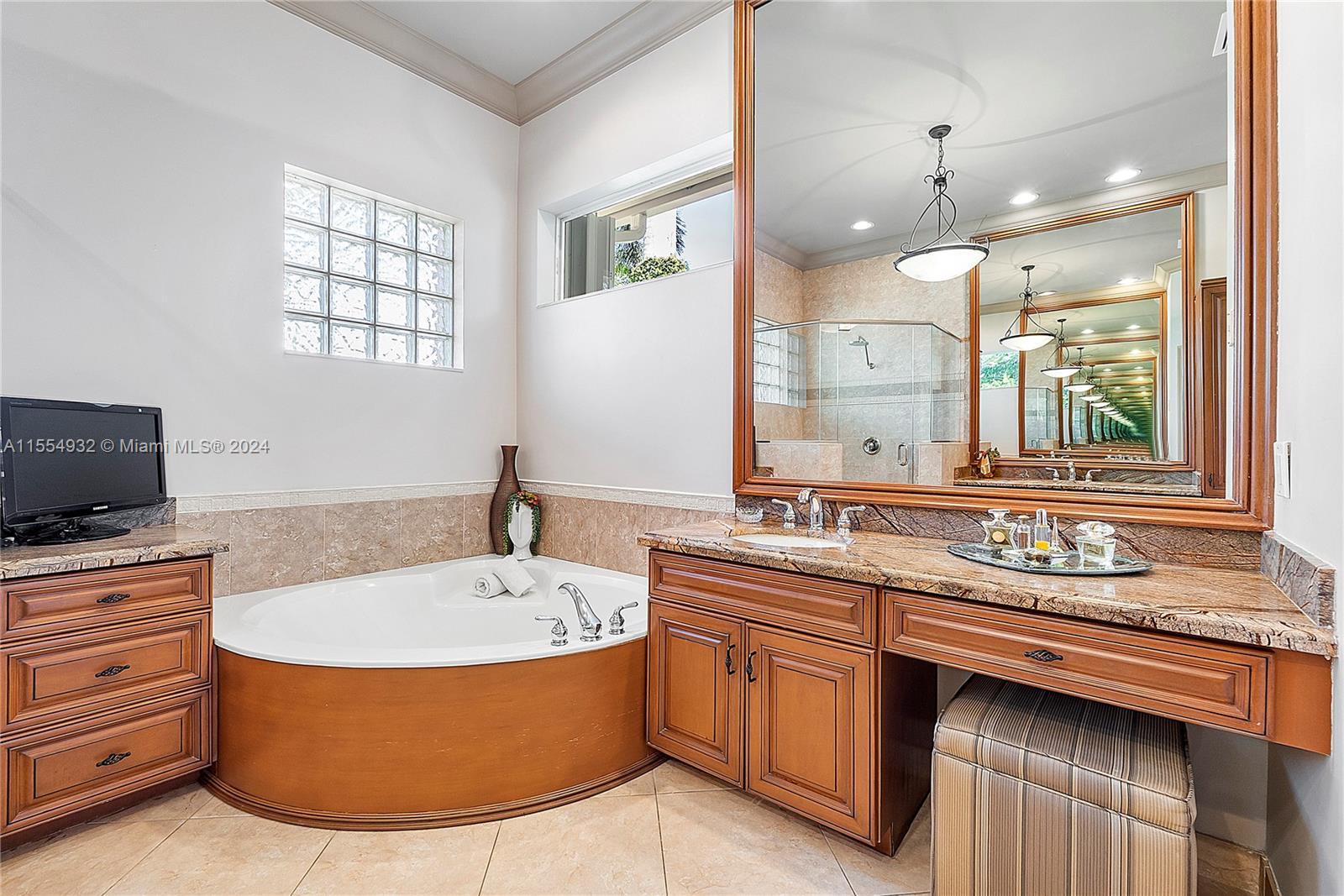 2539 Eagle Run Drive Weston, FL 33327 - Photo 39 of 64 a bathroom with a tub double sink window and mirror