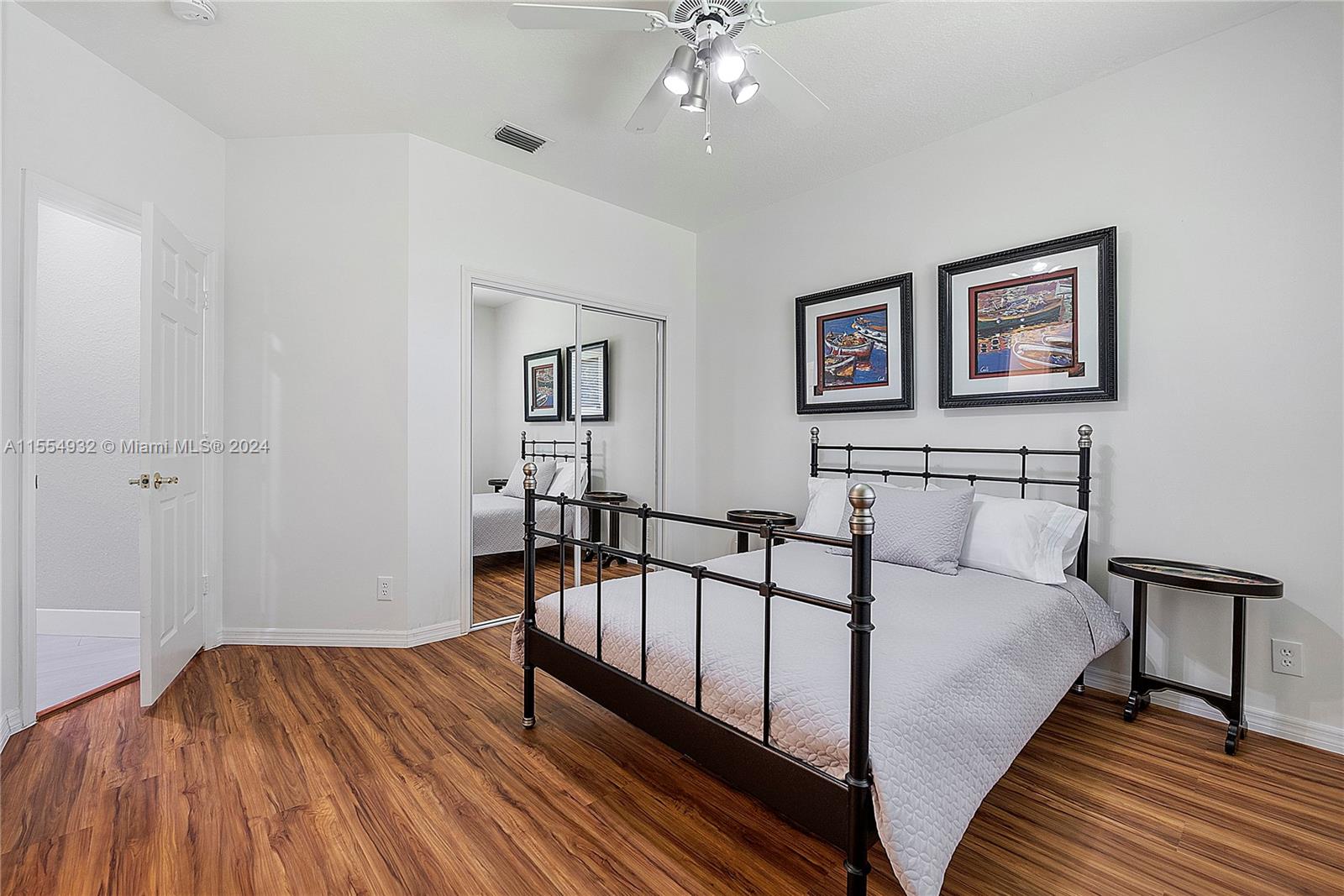 2539 Eagle Run Drive Weston, FL 33327 - Photo 42 of 64 a spacious bedroom with a bed and a table