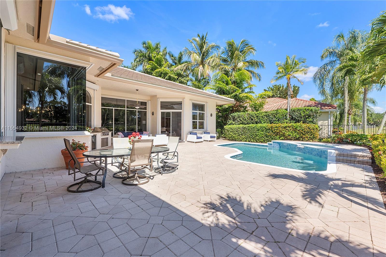 2539 Eagle Run Drive Weston, FL 33327 - Photo 48 of 64 a view of a patio with table and chairs potted plants and palm tree