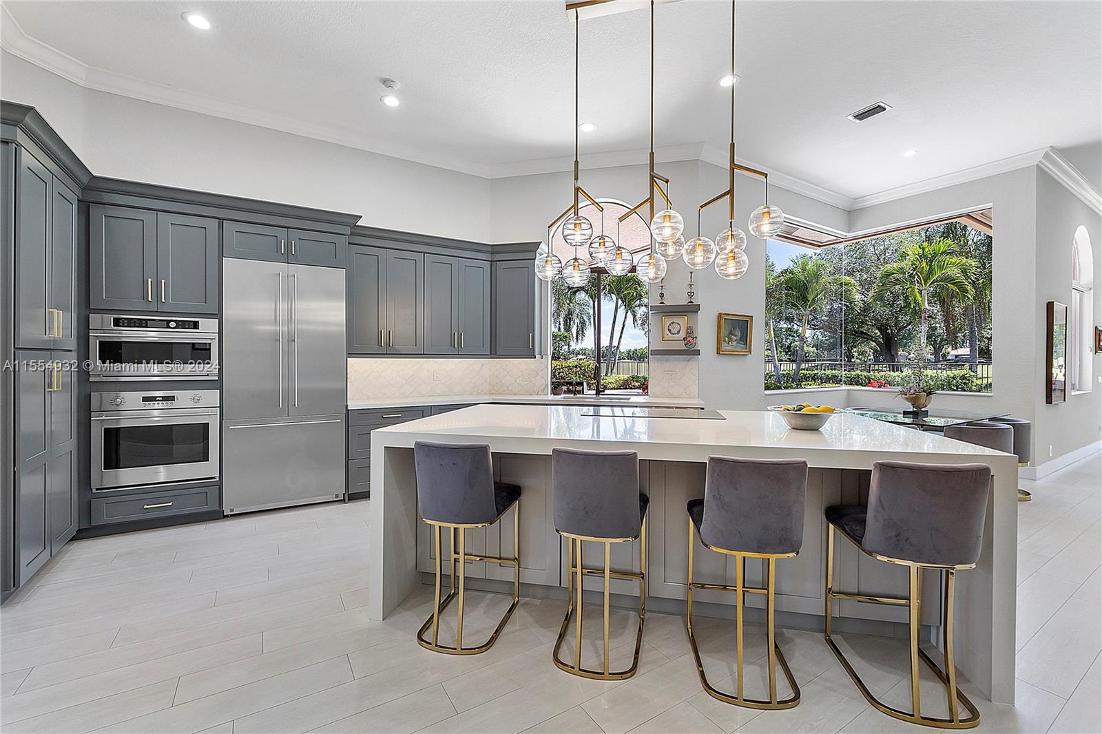2539 Eagle Run Drive Weston, FL 33327 - Photo 5 of 64 a kitchen with a table chairs refrigerator and cabinets