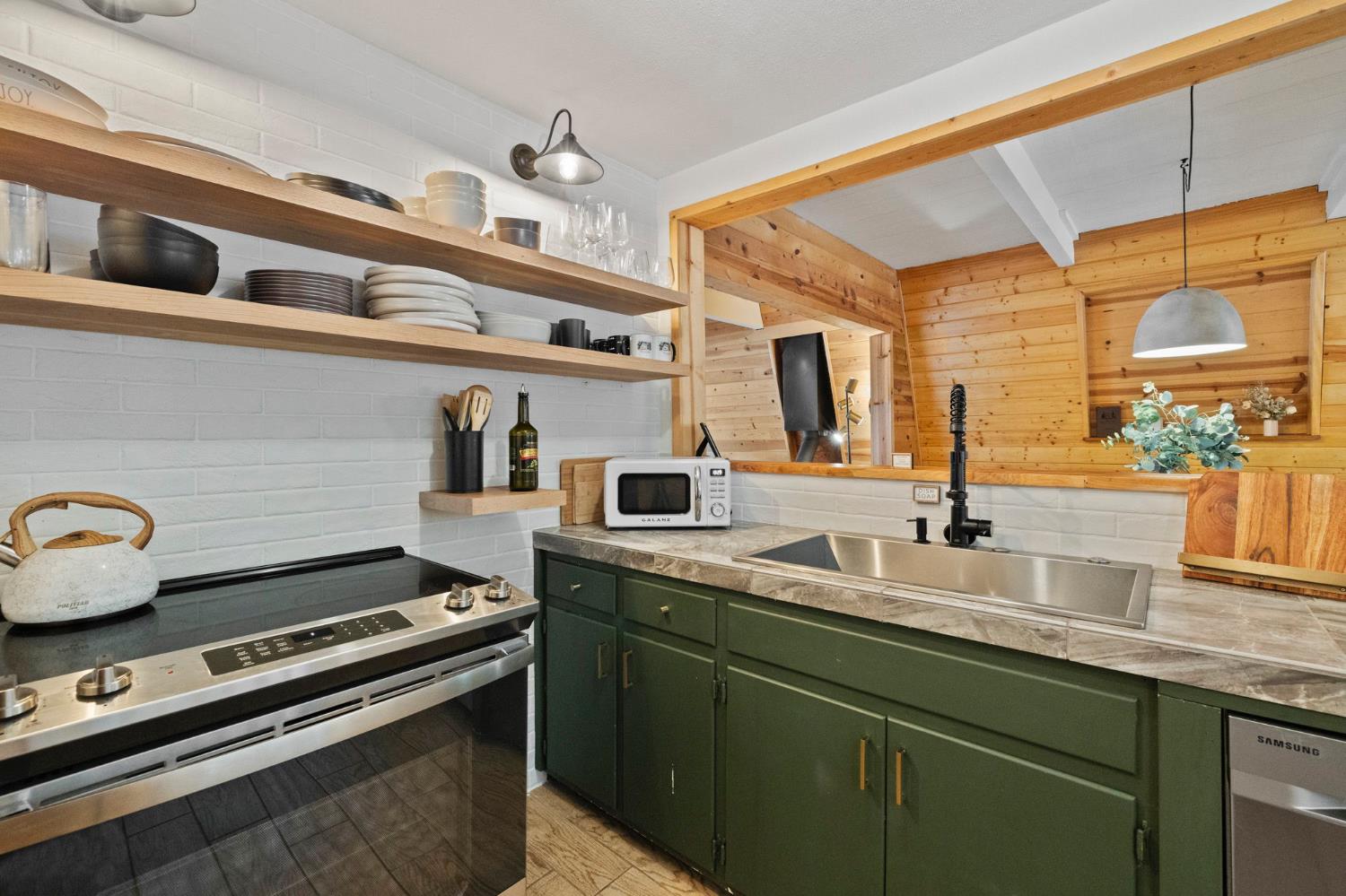 22785 West Ellmaro Road Long Barn, CA 95335 - Photo 11 of 28 a kitchen with a stove and a sink
