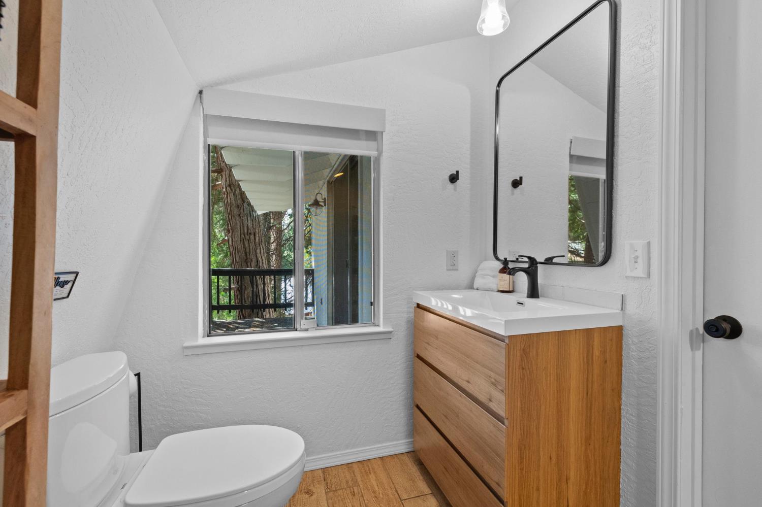22785 West Ellmaro Road Long Barn, CA 95335 - Photo 21 of 28 a bathroom with a toilet a sink and mirror