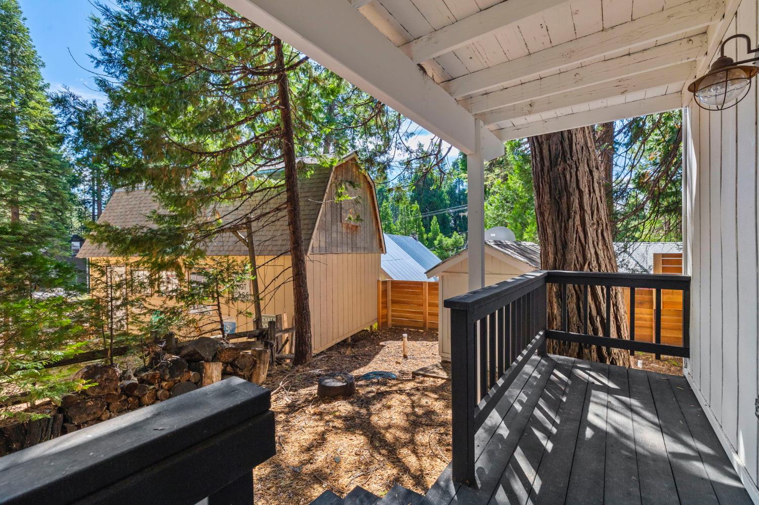 22785 West Ellmaro Road Long Barn, CA 95335 - Photo 25 of 28 a balcony with wooden floor and outdoor seating