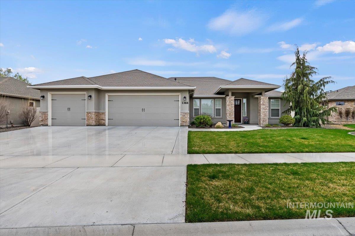 1366 North Waterbrook Way Star, ID 83669 - Photo 1 of 30 Prairie-style house featuring an attached garage, driveway, a front lawn, and stone siding