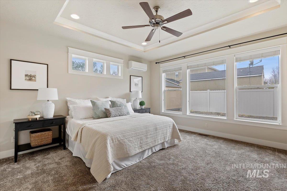 1366 North Waterbrook Way Star, ID 83669 - Photo 14 of 30 Carpeted bedroom featuring ceiling fan, a tray ceiling, and recessed lighting