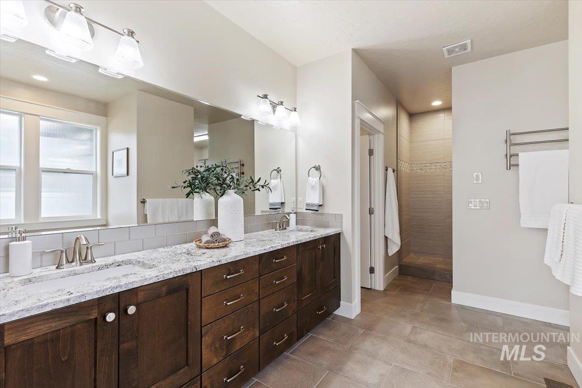 1366 North Waterbrook Way Star, ID 83669 - Photo 16 of 30 Bathroom featuring double vanity, recessed lighting, a walk in shower, and light tile patterned floors