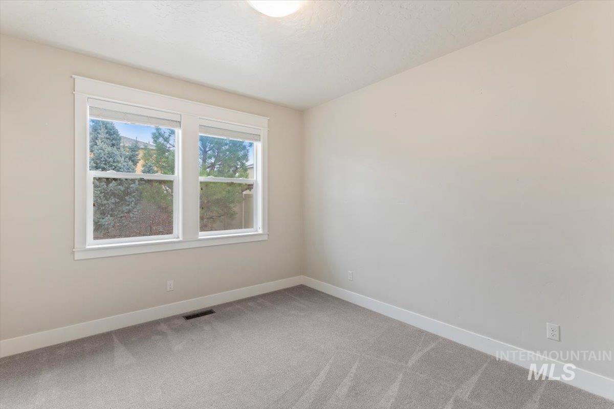 1366 North Waterbrook Way Star, ID 83669 - Photo 23 of 30 Empty room featuring light carpet and a textured ceiling