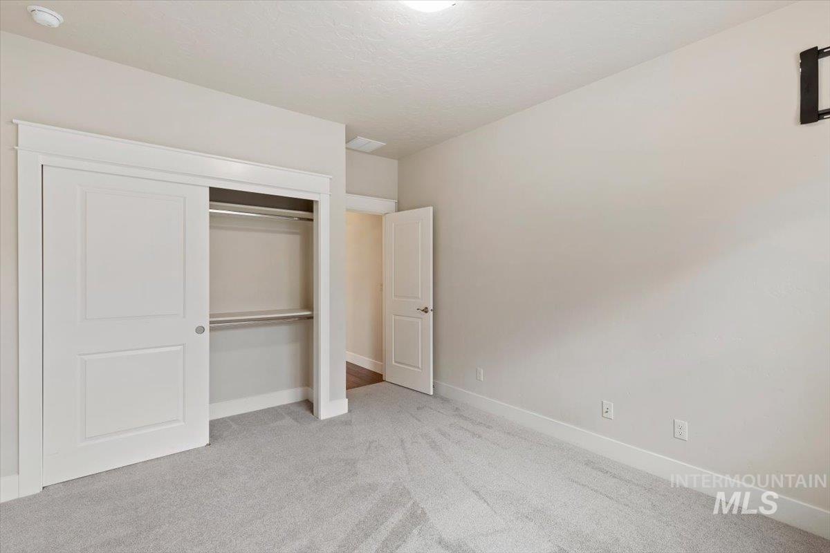 1366 North Waterbrook Way Star, ID 83669 - Photo 24 of 30 Unfurnished bedroom with light colored carpet and a closet