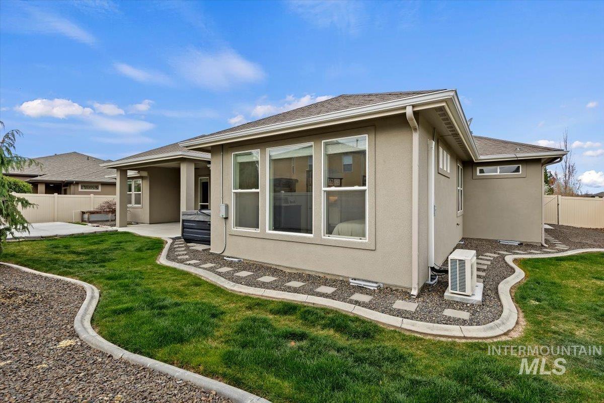 1366 North Waterbrook Way Star, ID 83669 - Photo 27 of 30 Back of property featuring stucco siding, a patio area, and a shingled roof