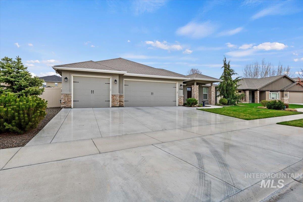 1366 North Waterbrook Way Star, ID 83669 - Photo 4 of 30 View of front of house featuring concrete driveway, an attached garage, and stone siding