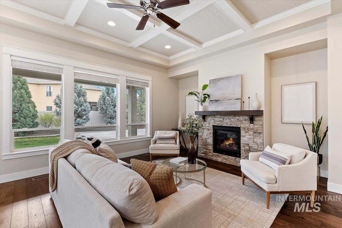 1366 North Waterbrook Way Star, ID 83669 - Photo 10 of 30 Living room with wood-type flooring, coffered ceiling, ceiling fan, a stone fireplace, and crown molding