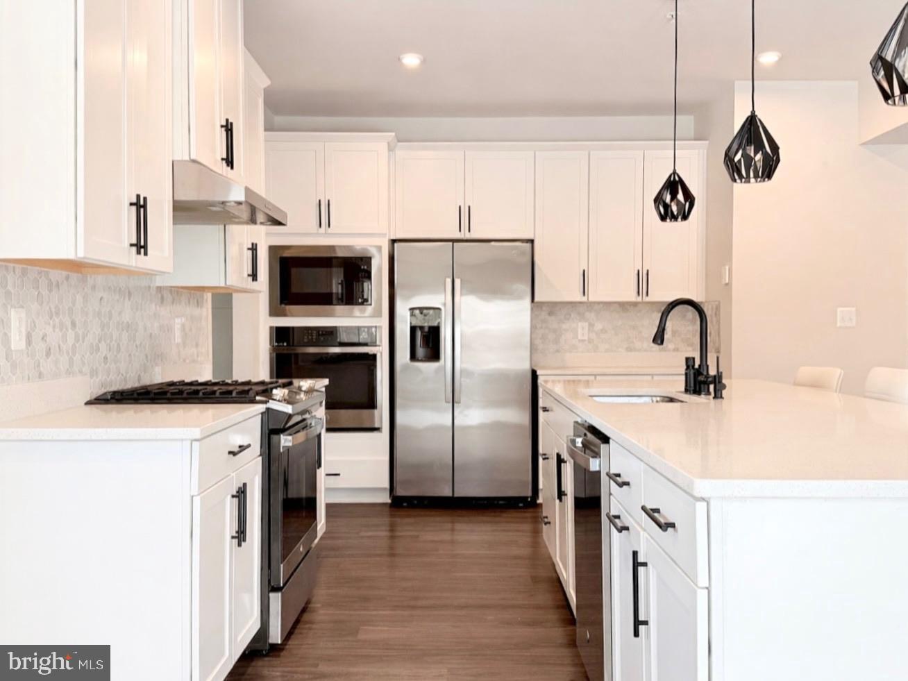11360 Wheeler Ridge Drive Manassas, VA 20109 - Photo 5 of 32 Sleek modern kitchen with elegant finishes.