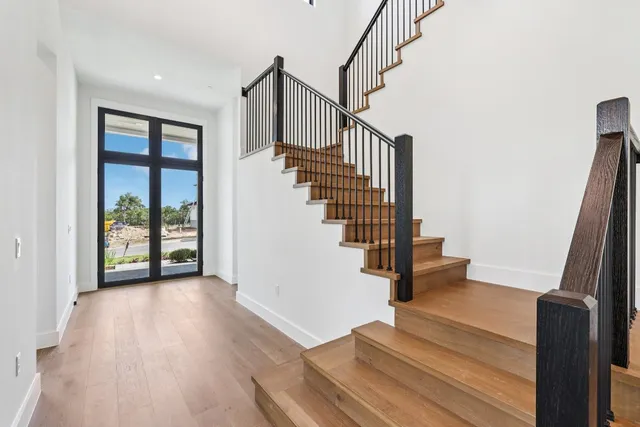 a view of entryway and hall with wooden floor