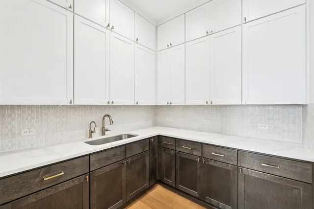 a kitchen with a sink and cabinets
