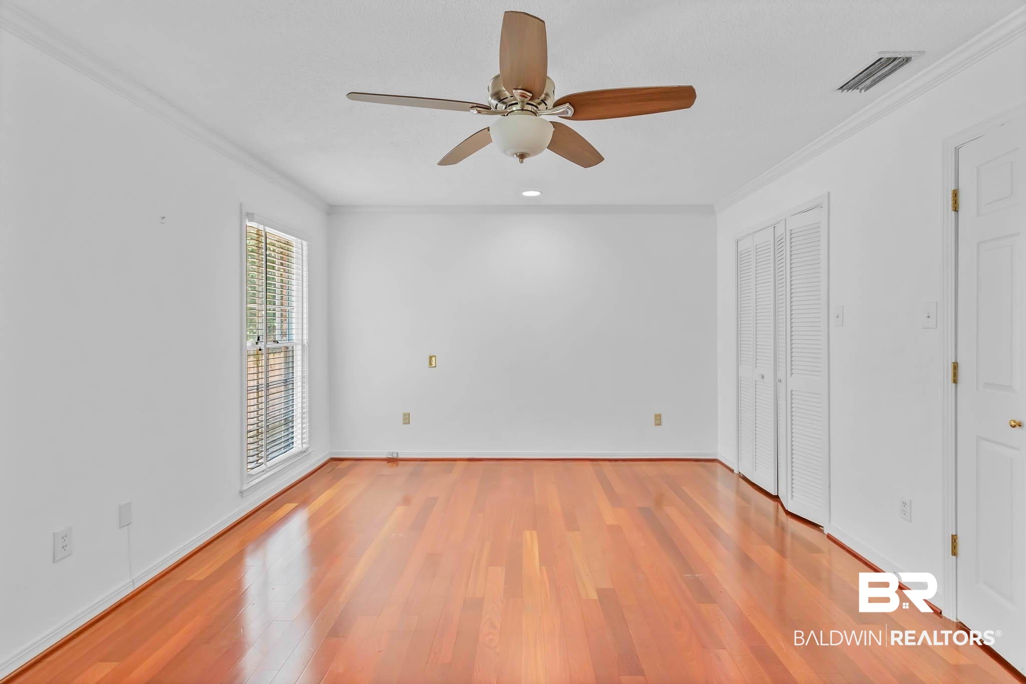 309 West Brandy Run Road Mobile, AL 36608 - Photo 37 of 100 Unfurnished bedroom featuring crown molding, light wood finished floors, ceiling fan, and a closet
