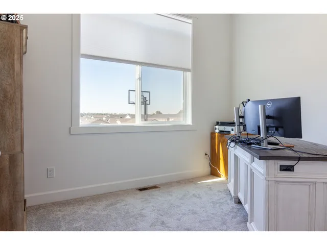 a kitchen with a stove a microwave and a window