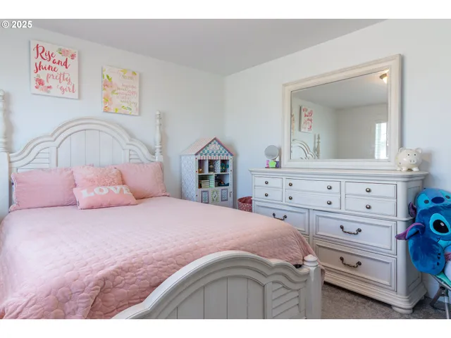 a bedroom with a bed and a dresser