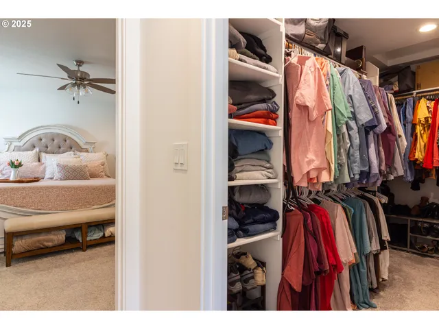 a kitchen with a refrigerator a dining table and chairs