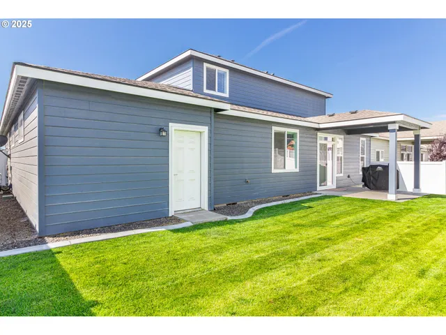 a view of a house with a yard and porch