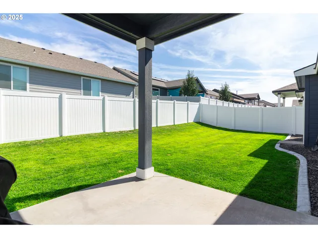 a kitchen with a table chairs a sink dishwasher stove and cabinets with wooden floor