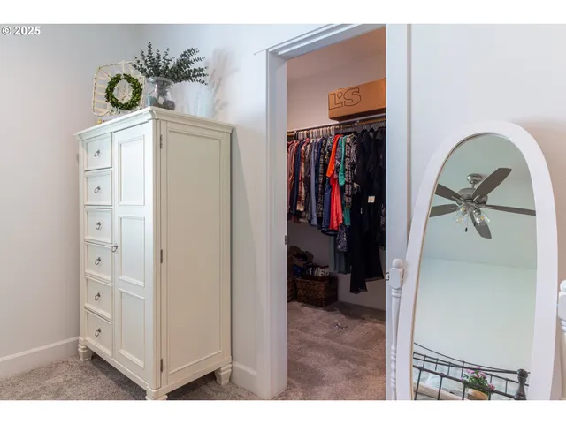 a view of walk in closet with clothes