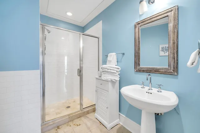 a bathroom with a sink a mirror and a shower